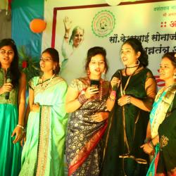 Student's performing group song in annual gathering.